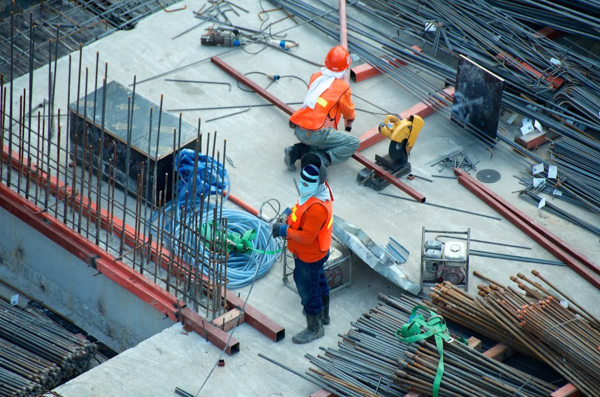 Construction workers and heavy equipment at a building site